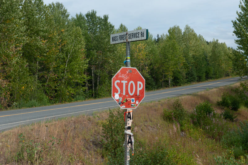 A sticker- and graffiti-covered stop sign on the Nass Forest Service Road