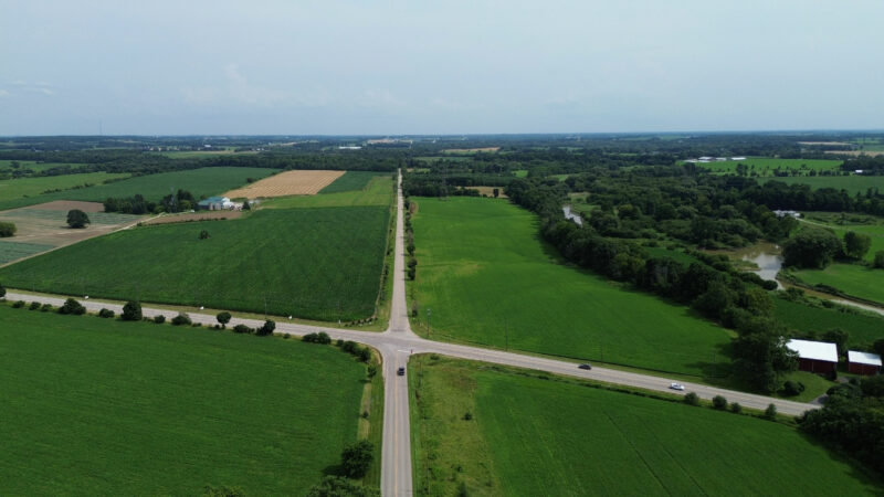 An aerial view of a rural intersection in The Township of Wilmot in the Regional Municipality of Waterloo in southwestern Ontario, Canada. Also visible are farmlands that the government is looking to expropriate for industrial use.