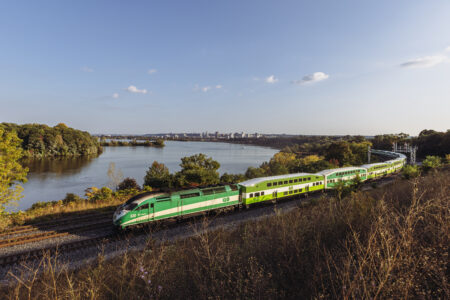 An east bound GO train departs Hamilton, Ontario along Lake Ontario.