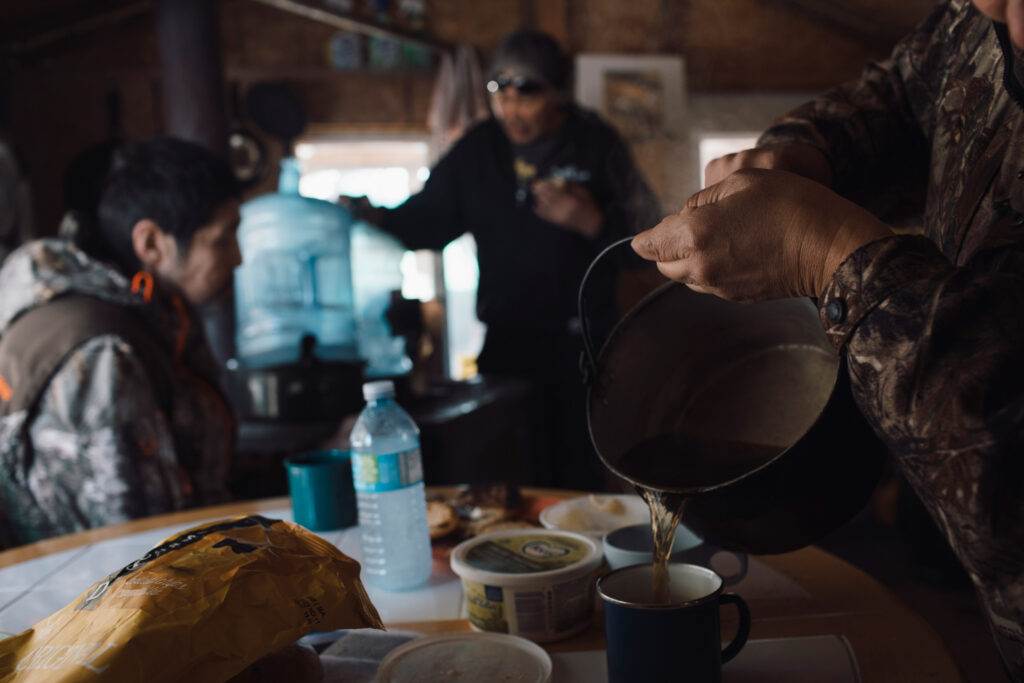 Jean L'Hommecourt pours tea made with bottled water at her cabin 13 km away from Imperial Oil's Kearl Lake oilsands mine near Fort McKay, Alberta.