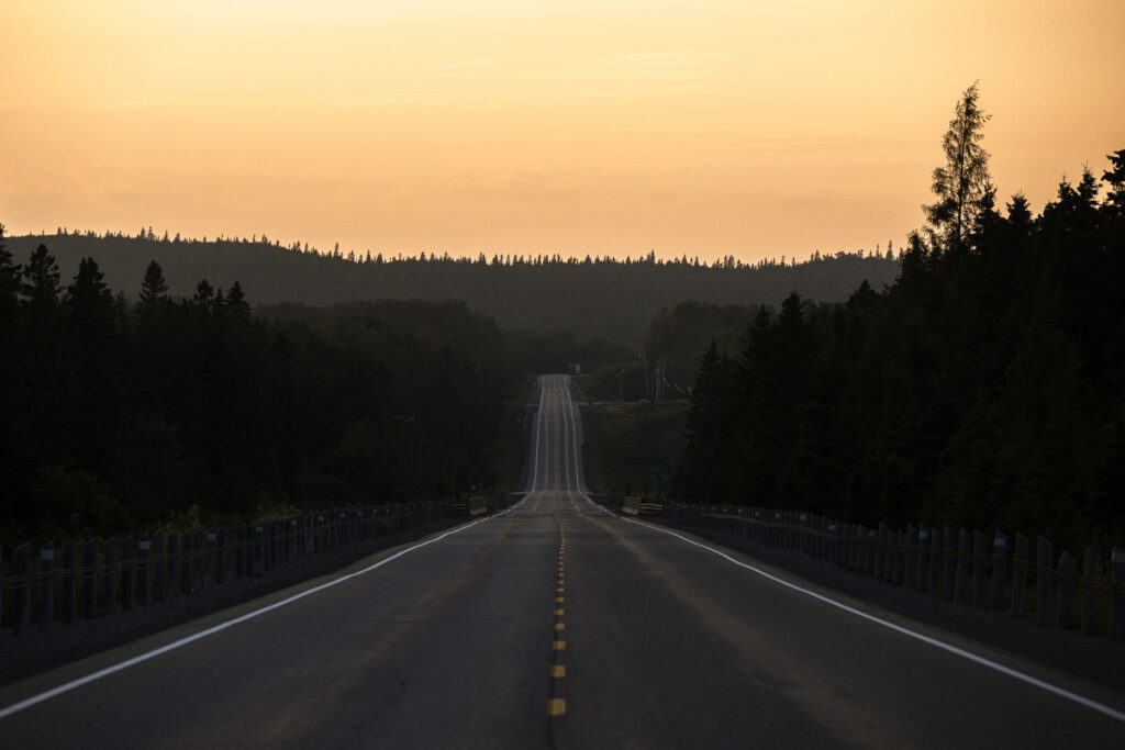 Lake Superior caribou: a highway running towards the horizon at sunset