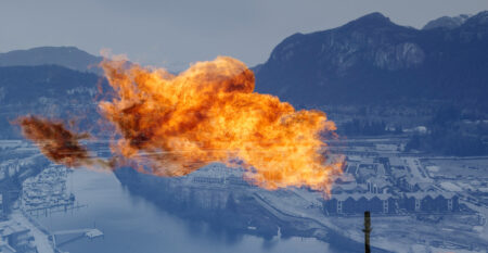 A flare stack from a liquid natural gas production facility is superimposed over a blue-tinted photo of Squamish, B.C.