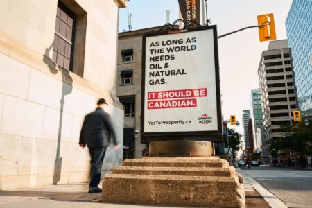 A Canada Action billboard ads in downtown Ottawa that reads "As long as the world needs oil & natural gas. It should be Canadian."