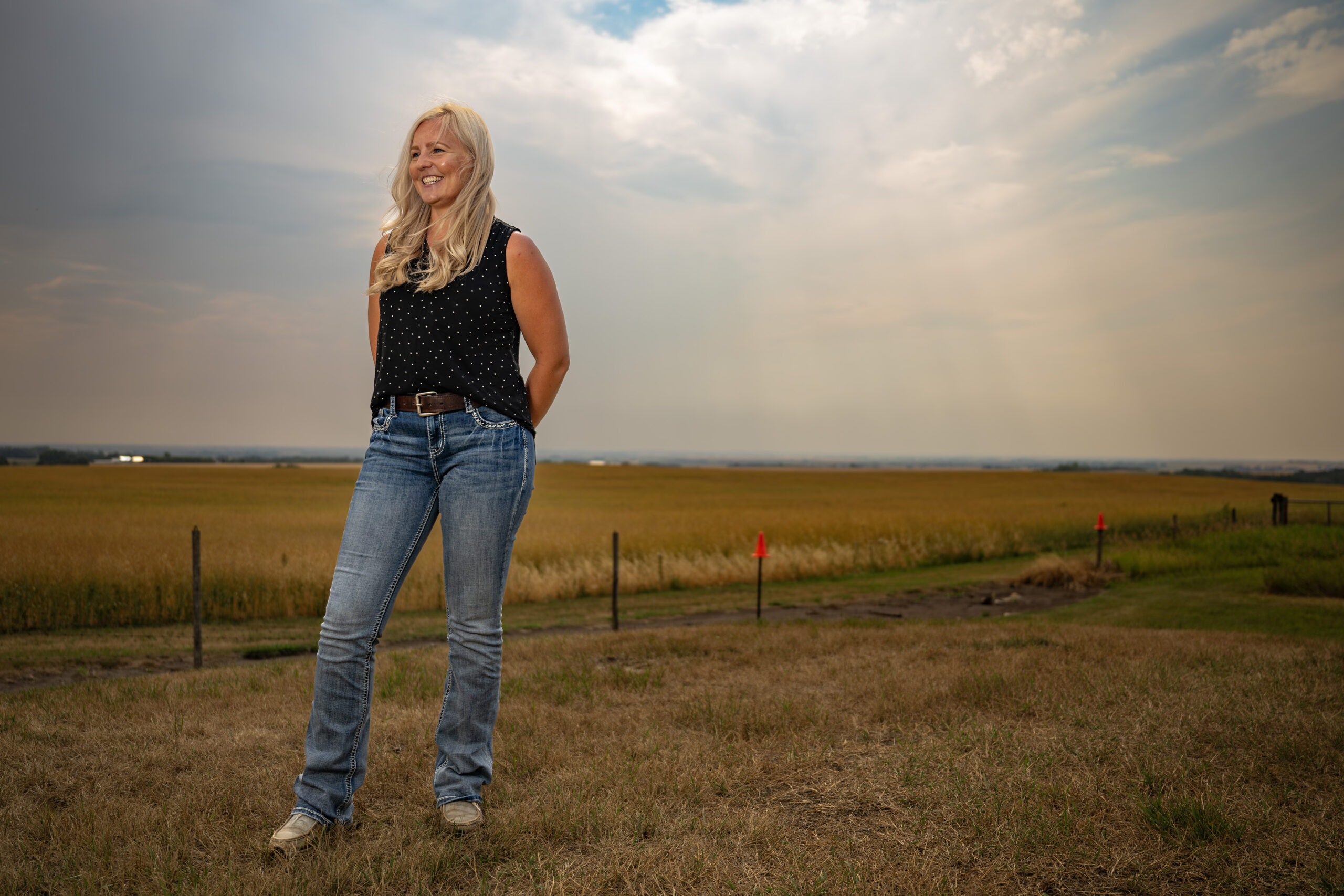 Kneehill County: Trish Tetz, a landowner in Kneehill County, poses for a photo with prairie fields in the background. 