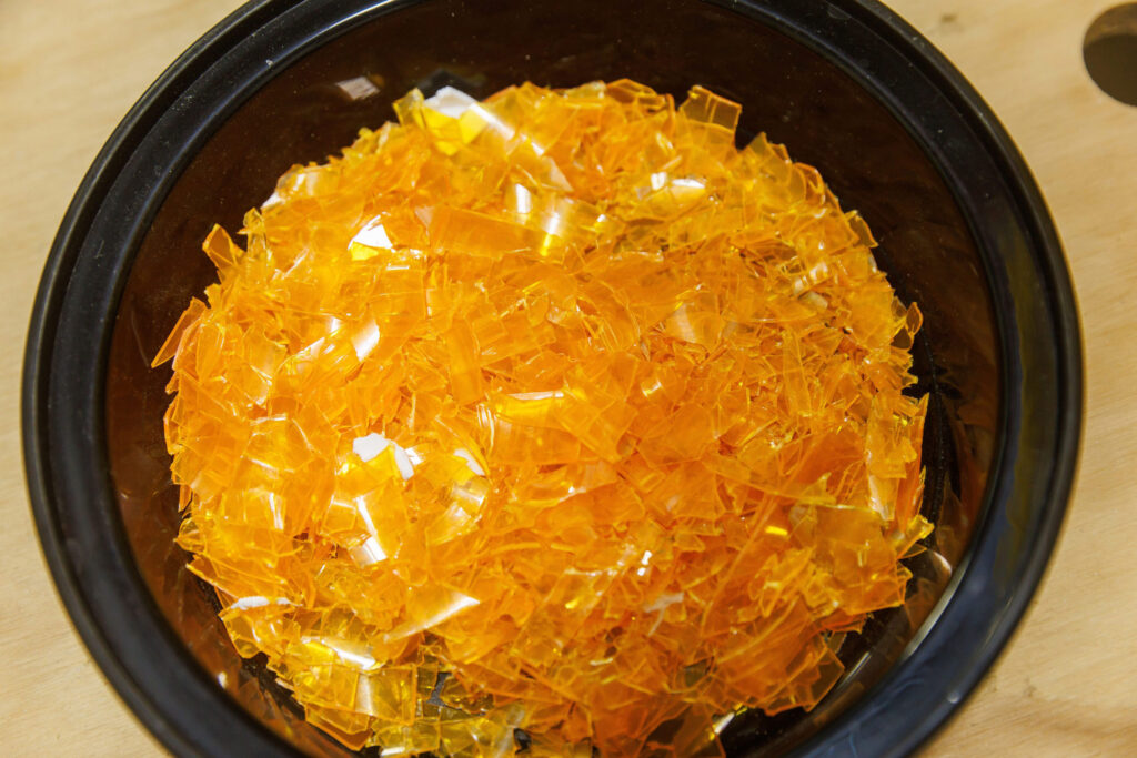 Shards of transparent orange plastic in a bowl