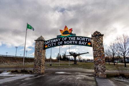 A sign over an archway reads 'Gateway of the North: City of North Bay'