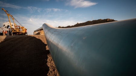 A photo of a length of pipeline, looking down its length as it stretches into the distance.