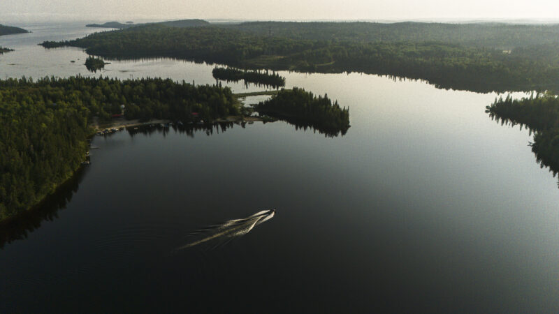 Ontario mining boozm: A boat crosses the water in the early morning on White Lake, an area that is blanketed with mining claims