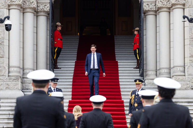 B.C. Premier David Eby walks down the red carpet on the steps of the provincial legislature