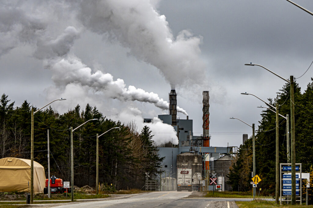 The view down a road that ends at smoke stacks at a pulp mill in Terrace Bay, Ont.