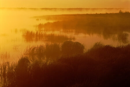 Riding Mountain National Park: a misty morning over Whirlpool lake in an orange light