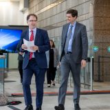 Premier David Eby and Energy Minister Adrian Dix walk together at a BC government announcement