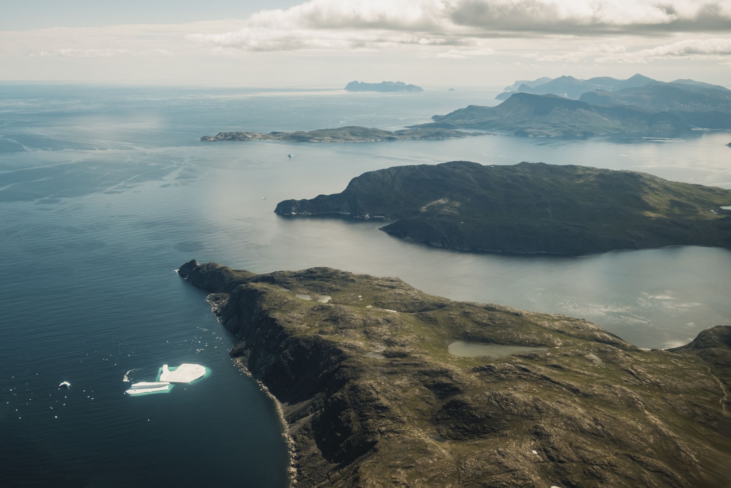 an iceberg floats along the coastline of northern Labrador