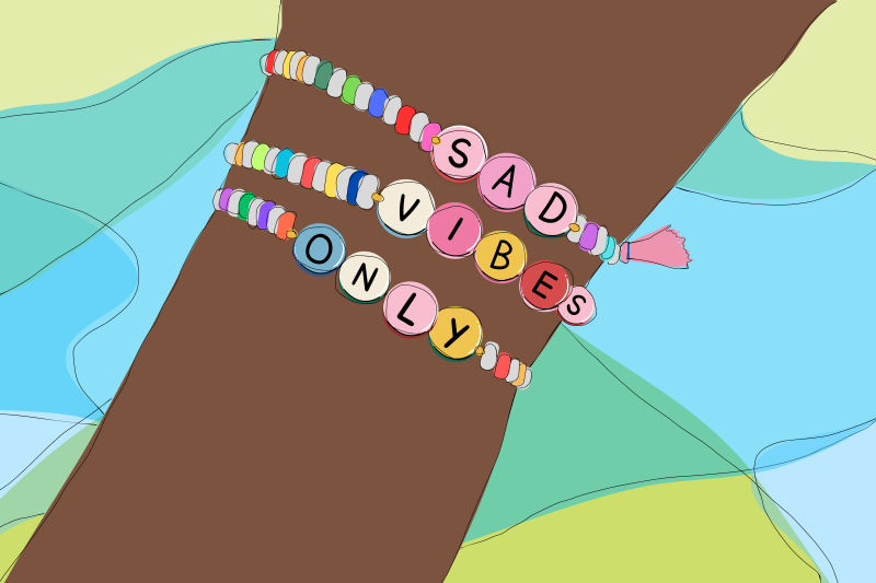 An illustration of a child's wrist wearing a colourful friendship bracelet that says "Bad Vibes Only"