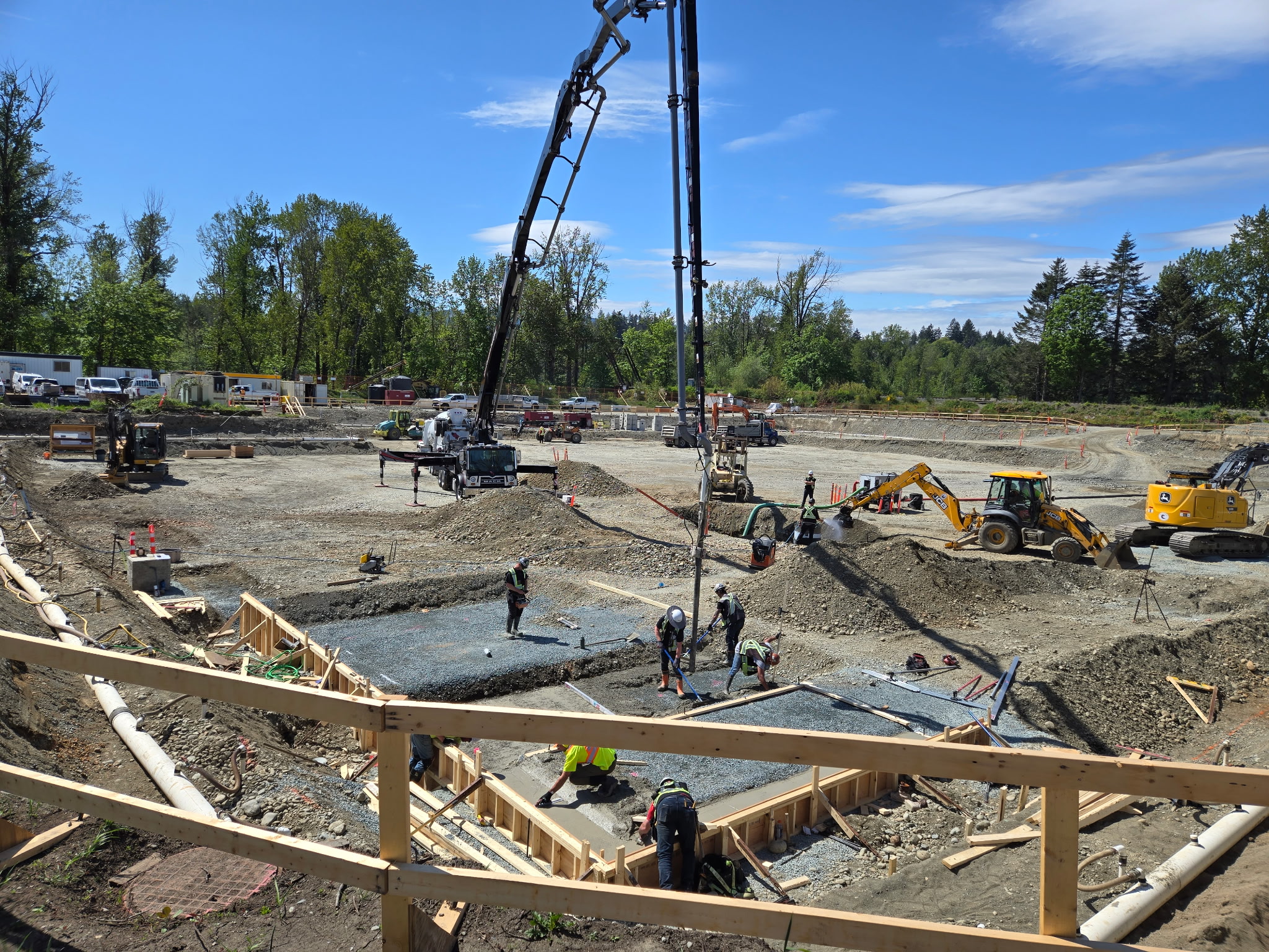 Cowichan Tribes' River's Edge development is under construction, with construction workers in the early stages of preparing the site.