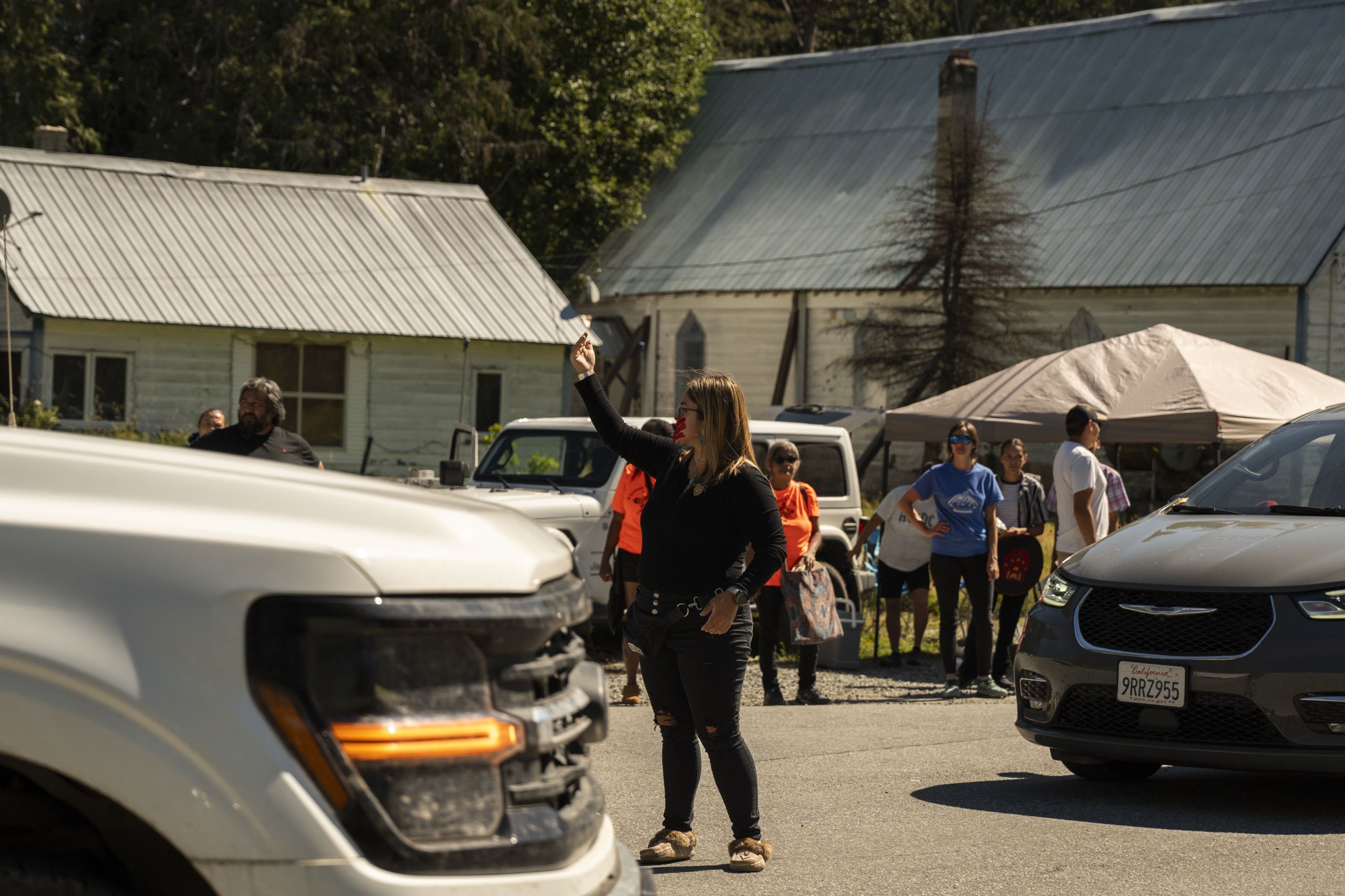 Lil'wat community member Kalentitikwa guides traffic after opening the road closure Líl̓wat and N’Quatqua Nations held on Highway 99 in Mount Currie