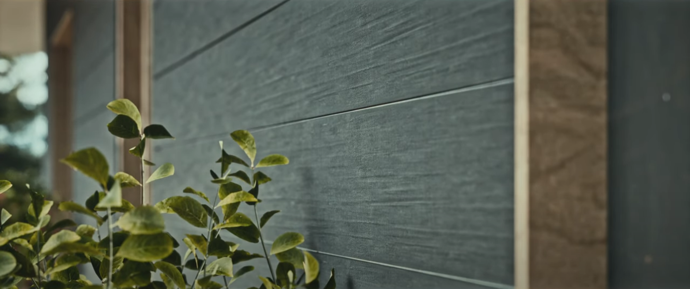 Yunesit'in wildfire-resilient house rendering of the scorched wood exterior walls, which are more resistant to catching fire