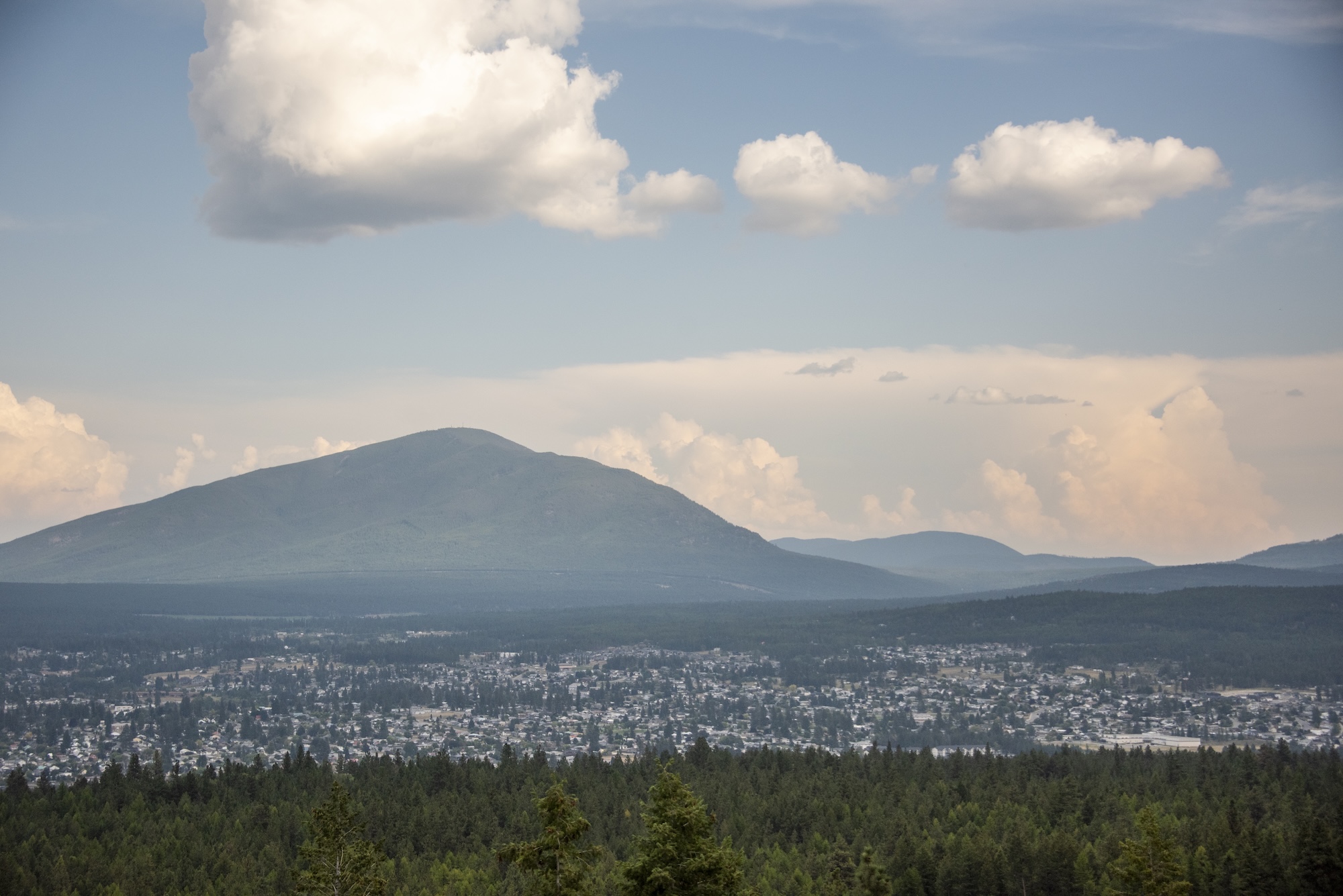 A view of the town of Canmore with the city below and mountain behind