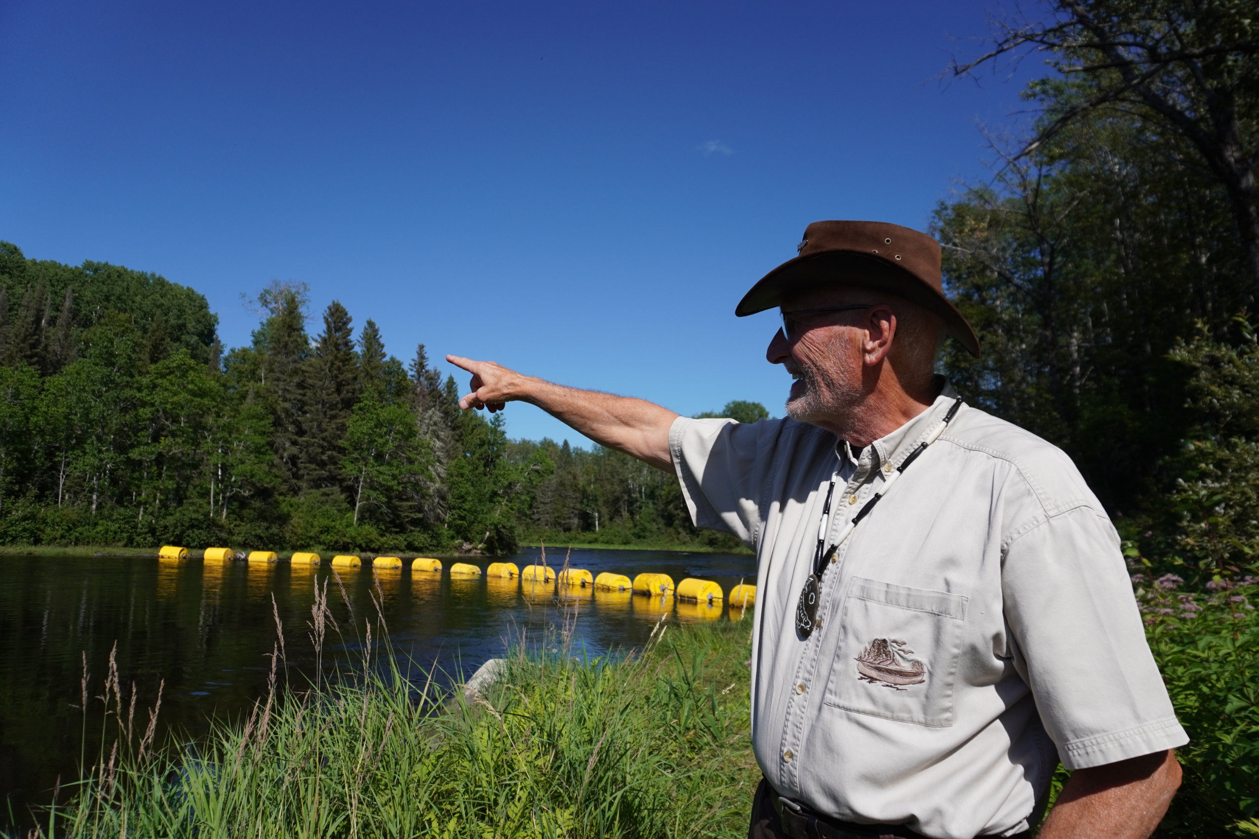 Laurent Robichaud, a director of the Ontario Rivers Alliance, points toward a river near Timmins, Ont.
