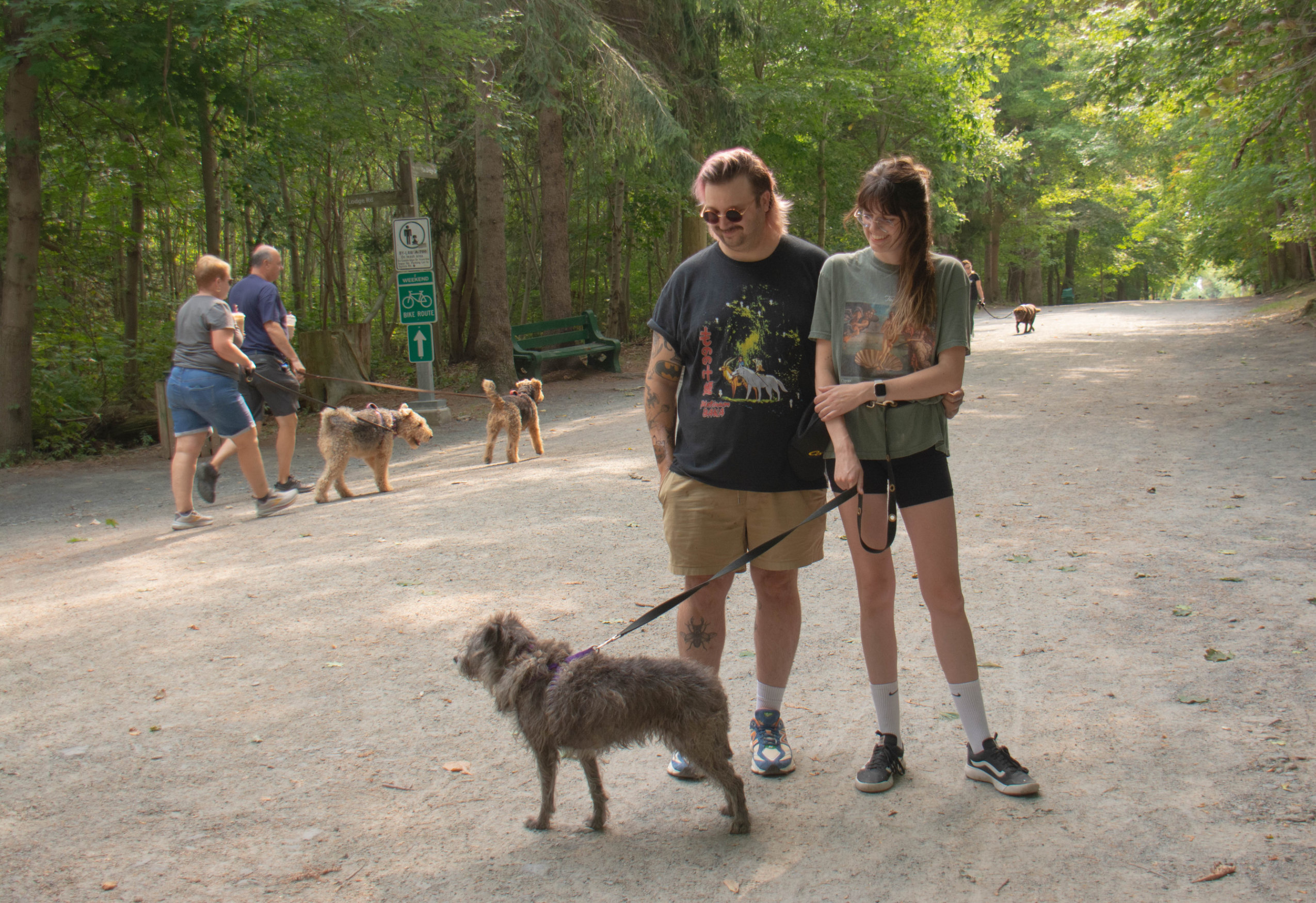 Two people stand with their dog on a trail in Halifax's Point Pleasant Park, which was recently reopened after weeks of closure due to the Nova Scotia government's woods ban.