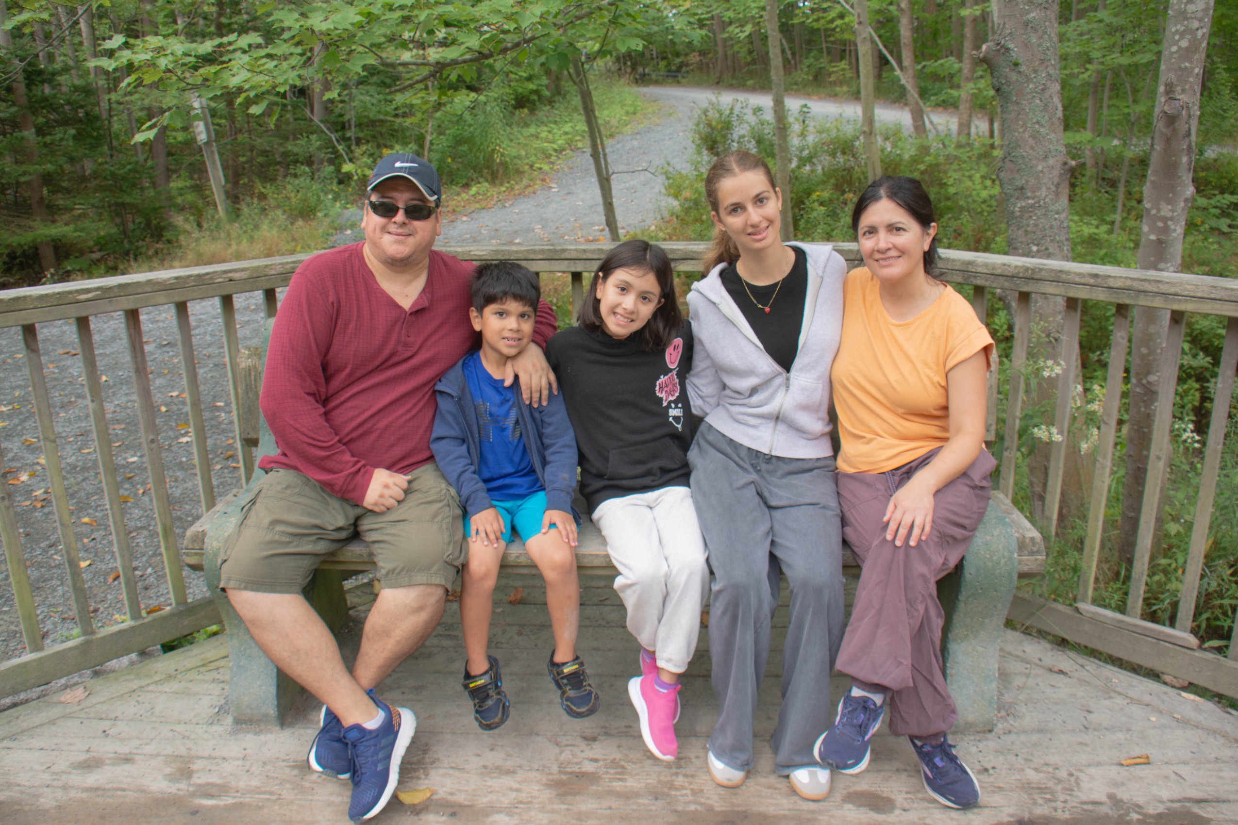 A group of five people including adults and children pose for a photo in Dartmouth's Shubie Park, which recently reopened after weeks of closure due to the Nova Scotia government's woods ban.