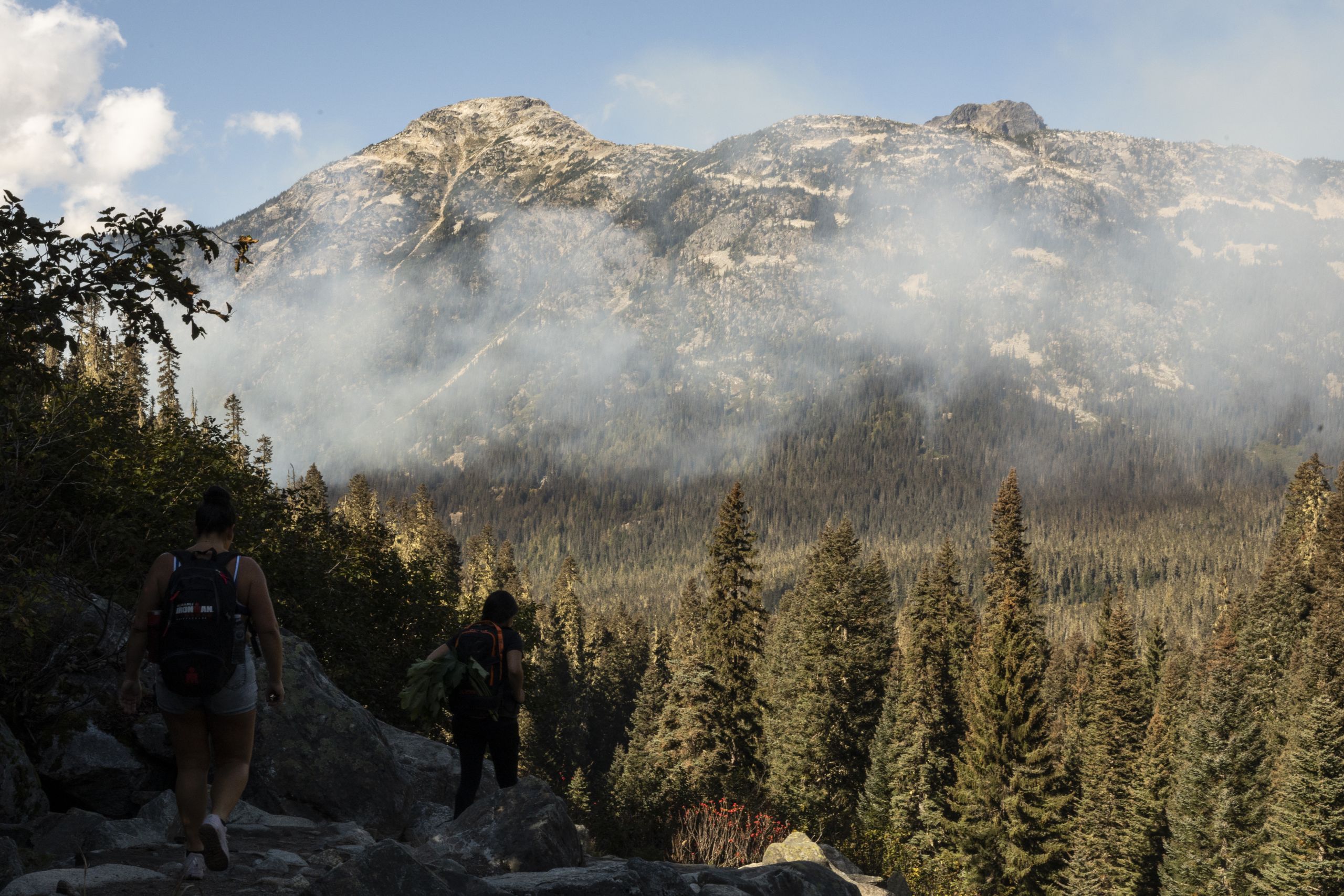 A trail of smoke is lined over the trees at Joffre Lakes, coming from a cultural burn a short distance away.