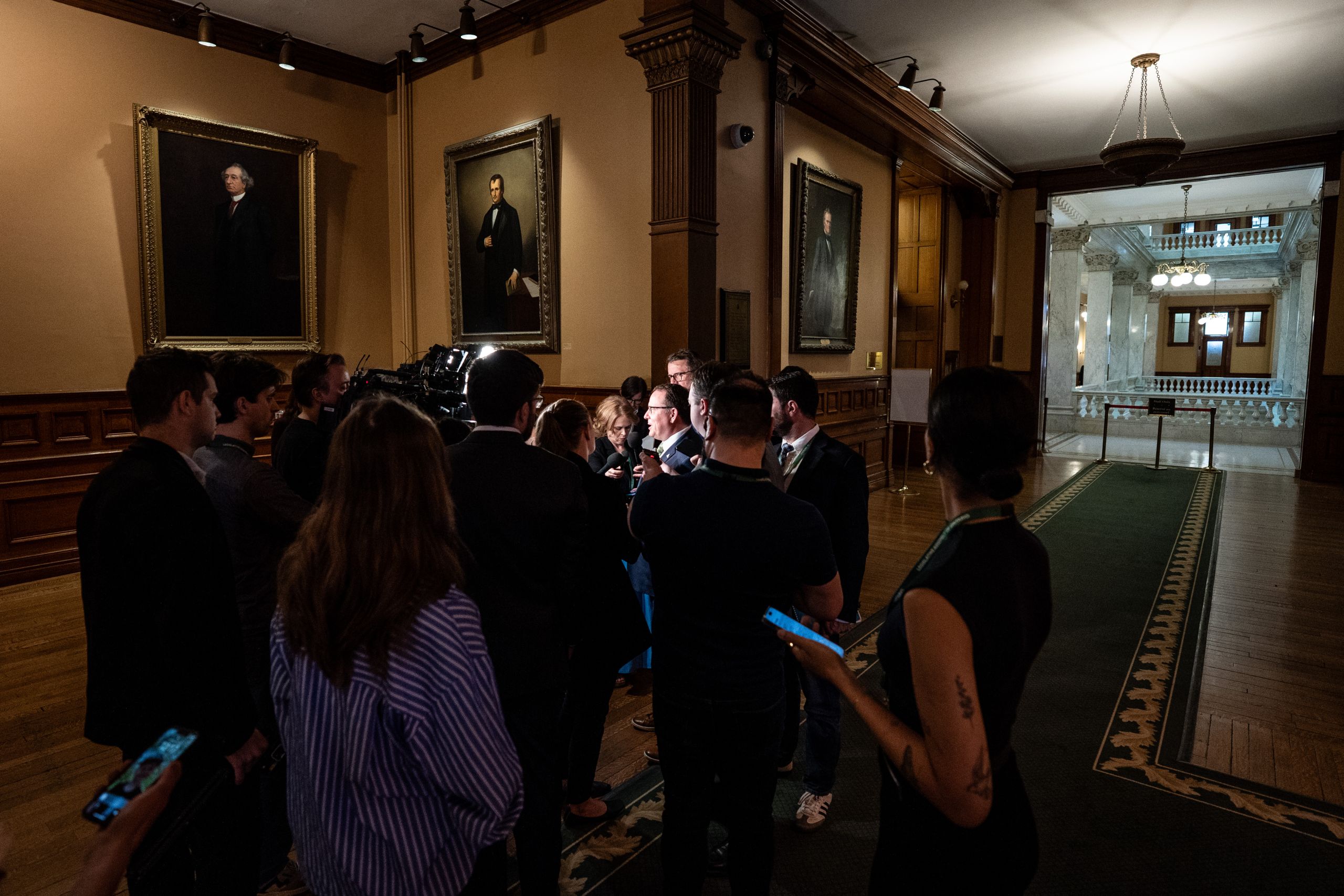 Ontario Greens Leader Mike Schreiner surrounded by media in a hallway at Queen's Park