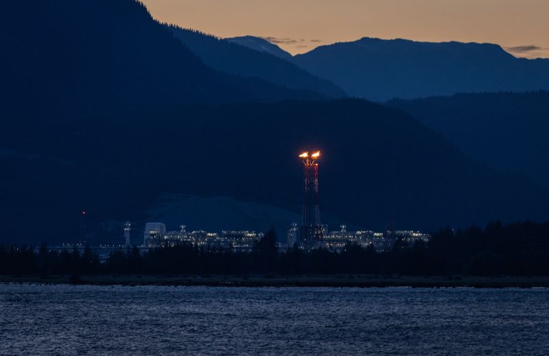 LNG Canada flarestack in Kitimat, B.C., from across the Douglas Channel, at dusk