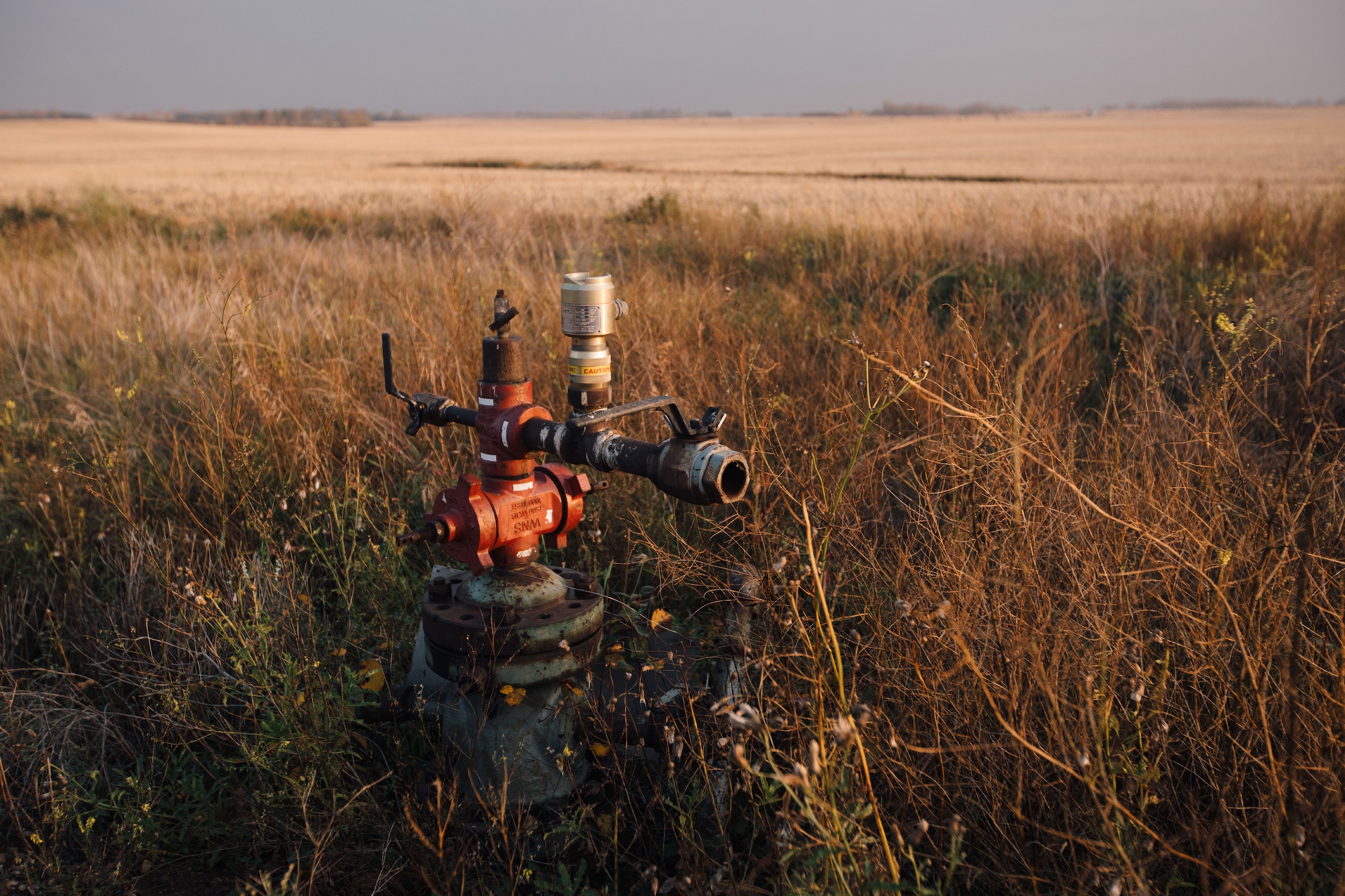 A red gas well in a rural Albertan field.
