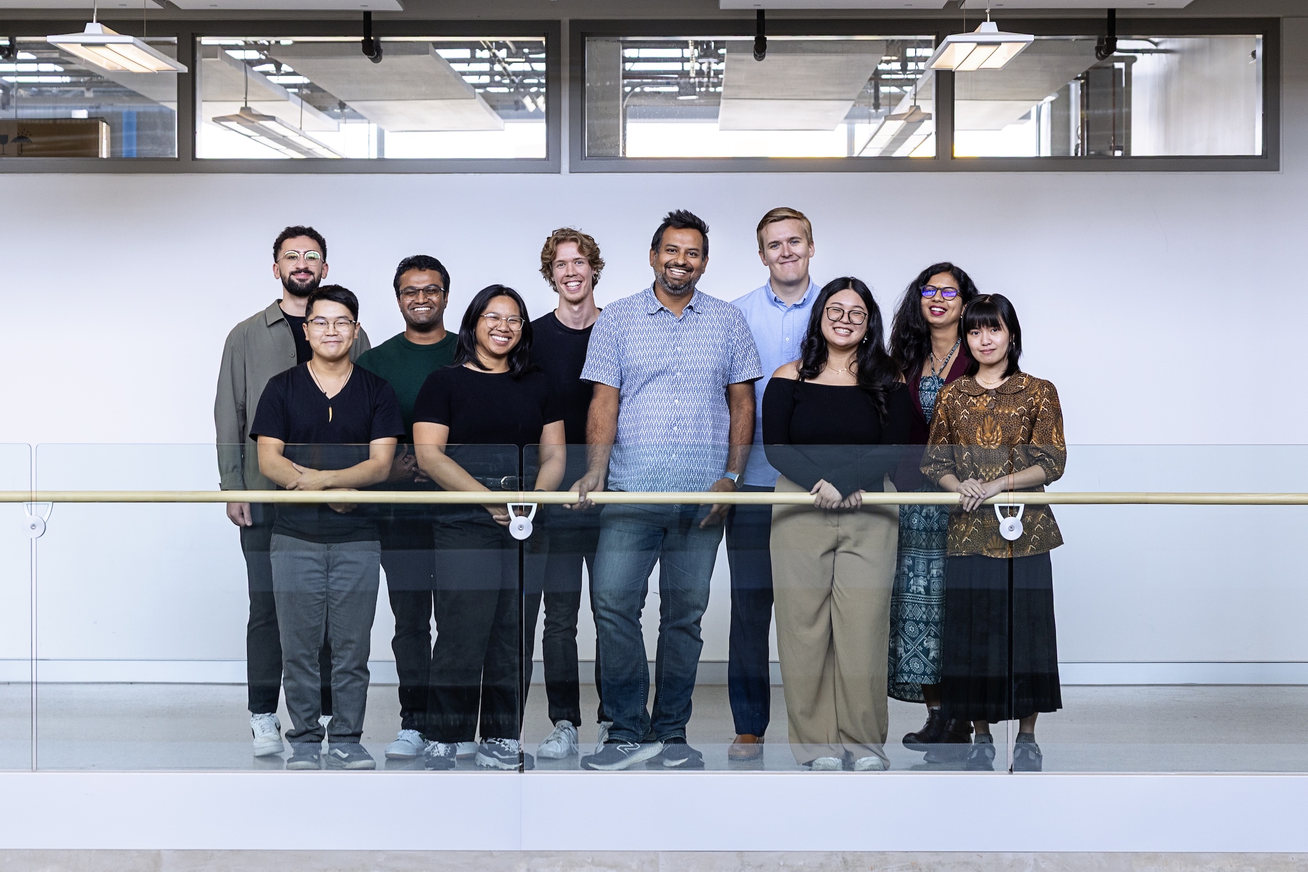 A group of researchers pose to have their photo taken together.