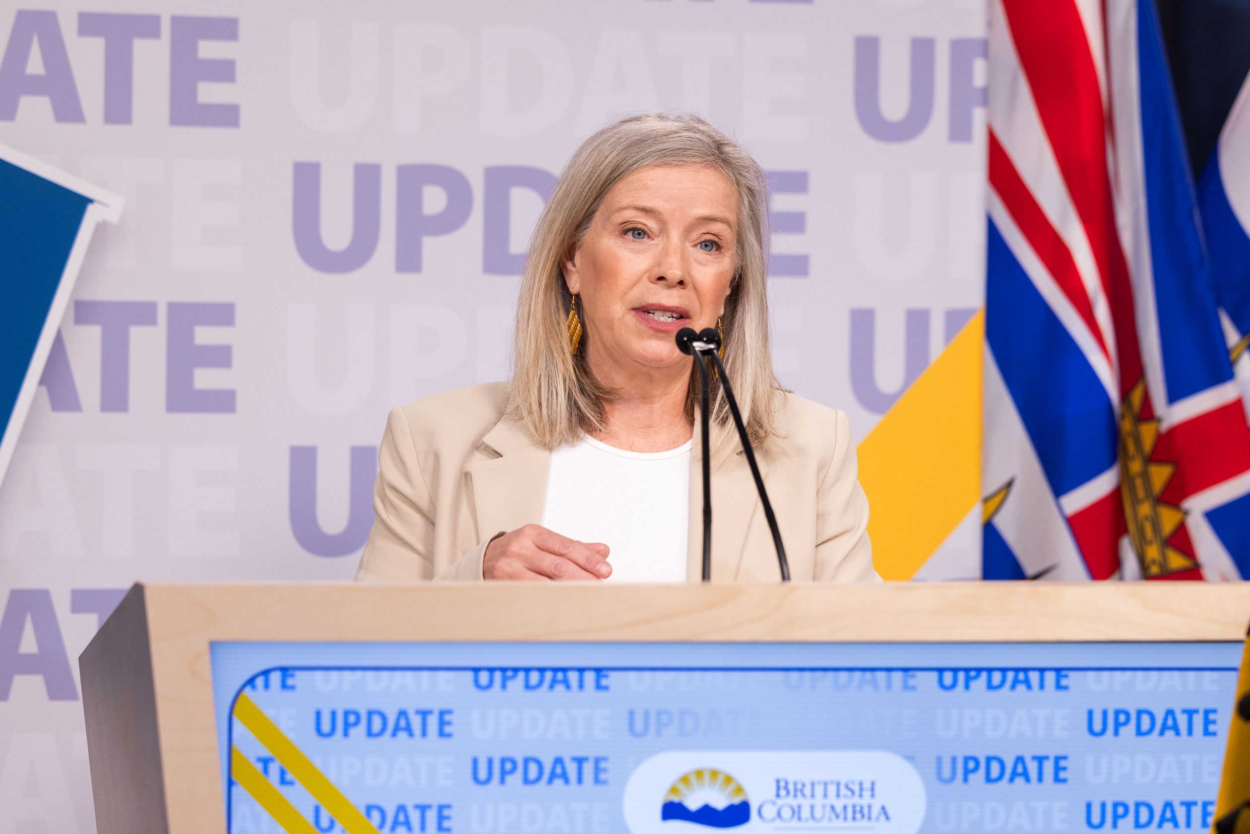a photo of Water, Land and Resource Stewardship Minister Randene Neill at a government podium with the BC flat next to her