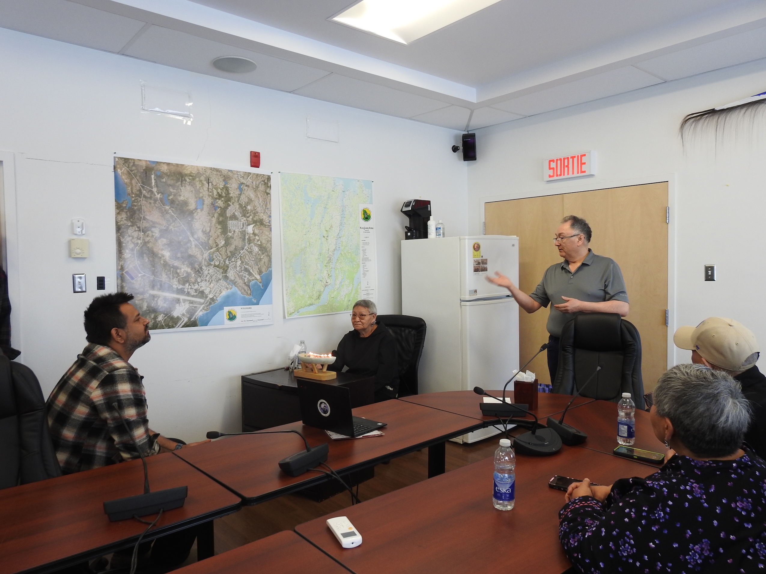 A group of people gathered around a boardroom table.