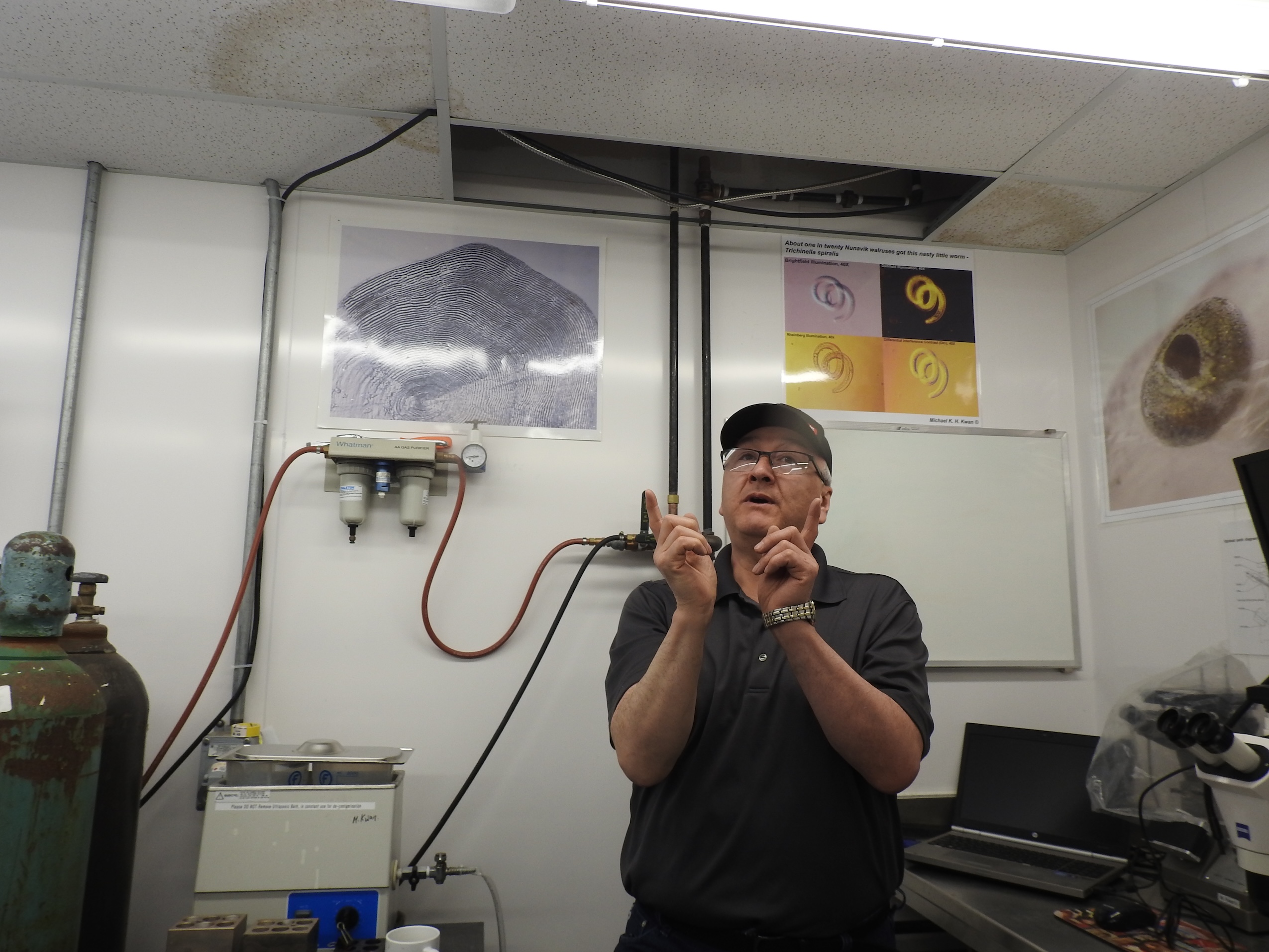 Researcher Allen Gordon demonstrating the length of a salmon with his fingers.