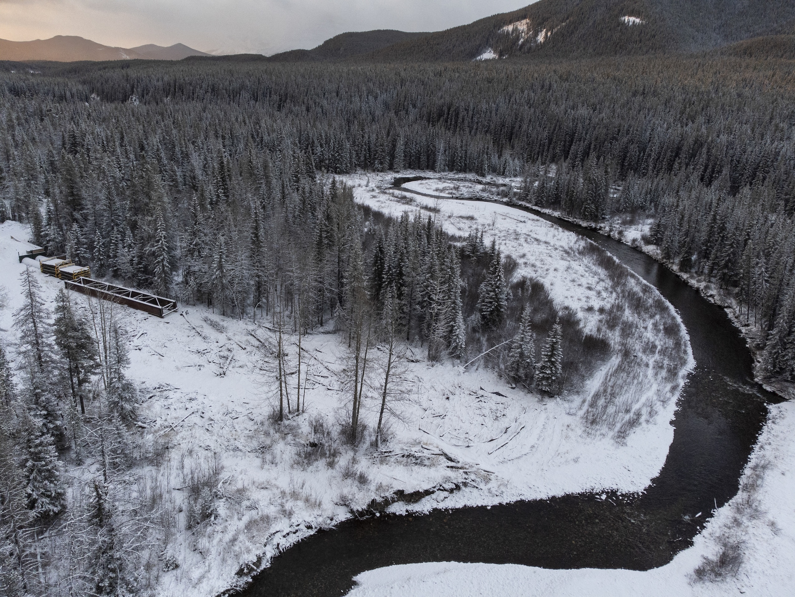 A river bend on a snow-covered forest landscape.