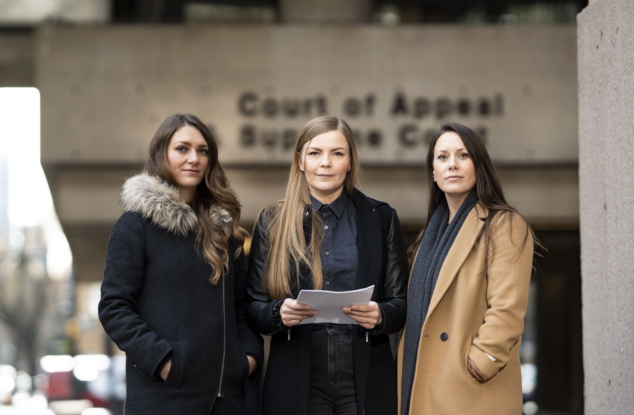 (Left to right) The Narwhal's Emma Gilchrist, photojournalist Amber Bracken and The Narwhal's Carol Linnitt stand outside the B.C. Supreme Court in February 2023, after filing a lawsuit against the RCMP.