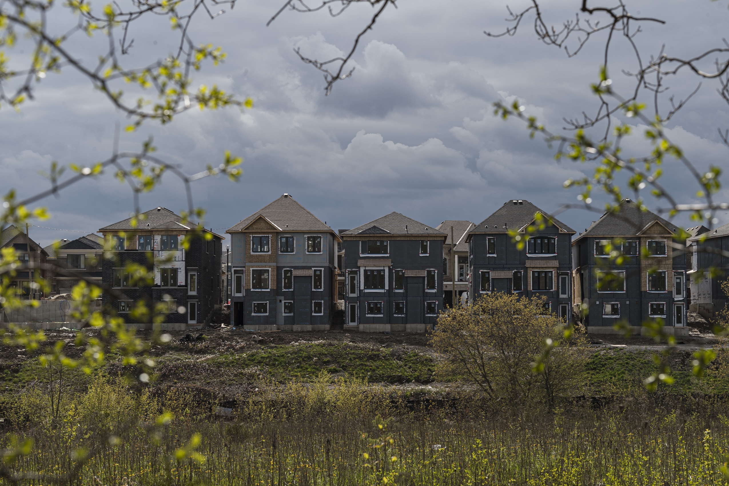 A row of houses under construction in a subdivision.