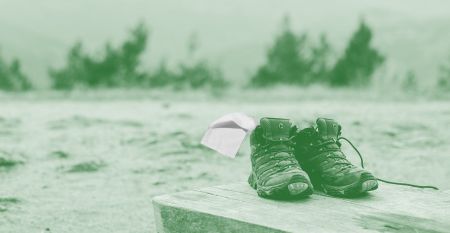 Photo illustration of hiking boots on a picnic table with pink toilet paper hanging off, behind a green filter