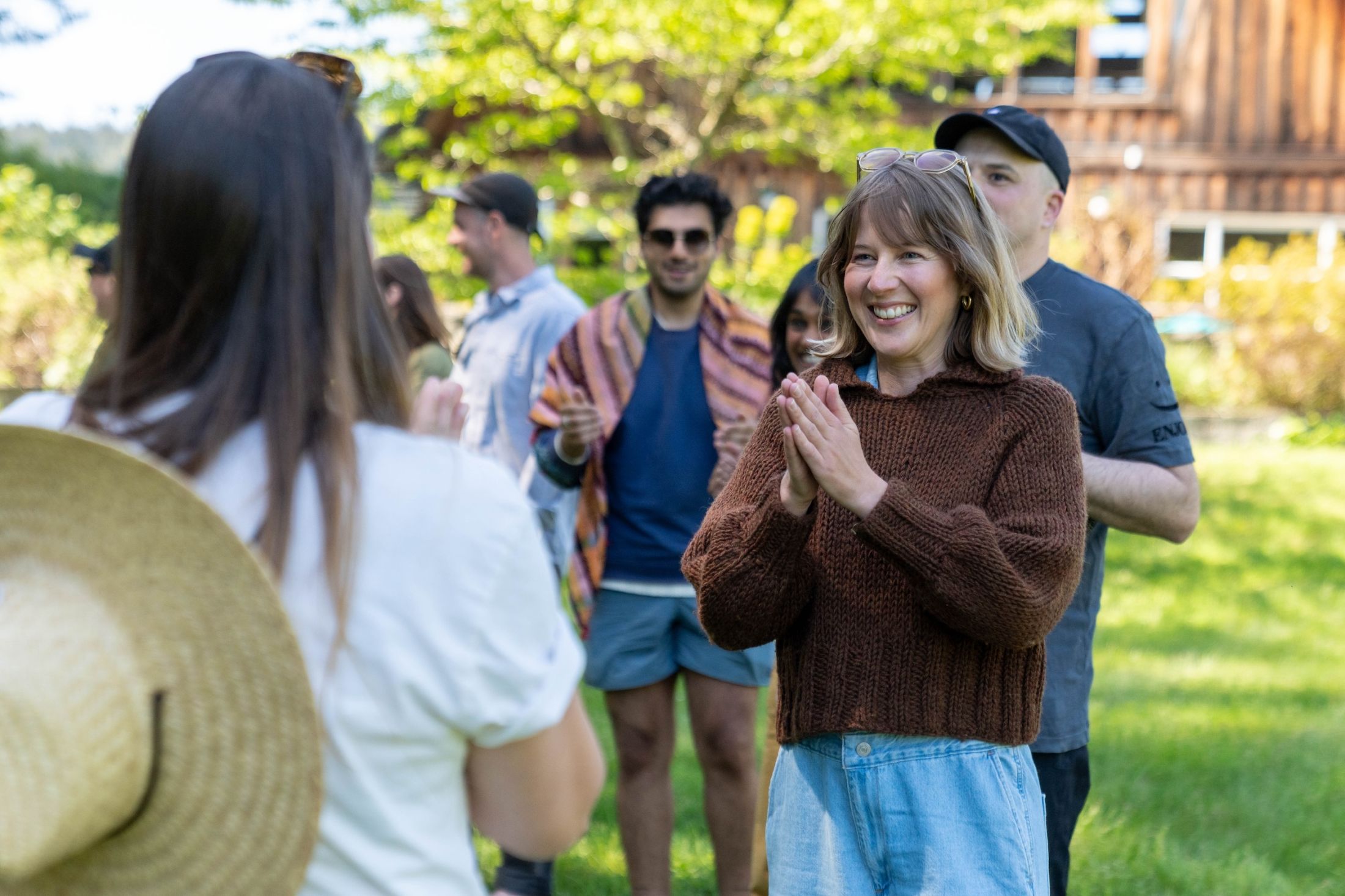 A photo of Narwhal staff playing a clapping game, with Kathryn front and centre.