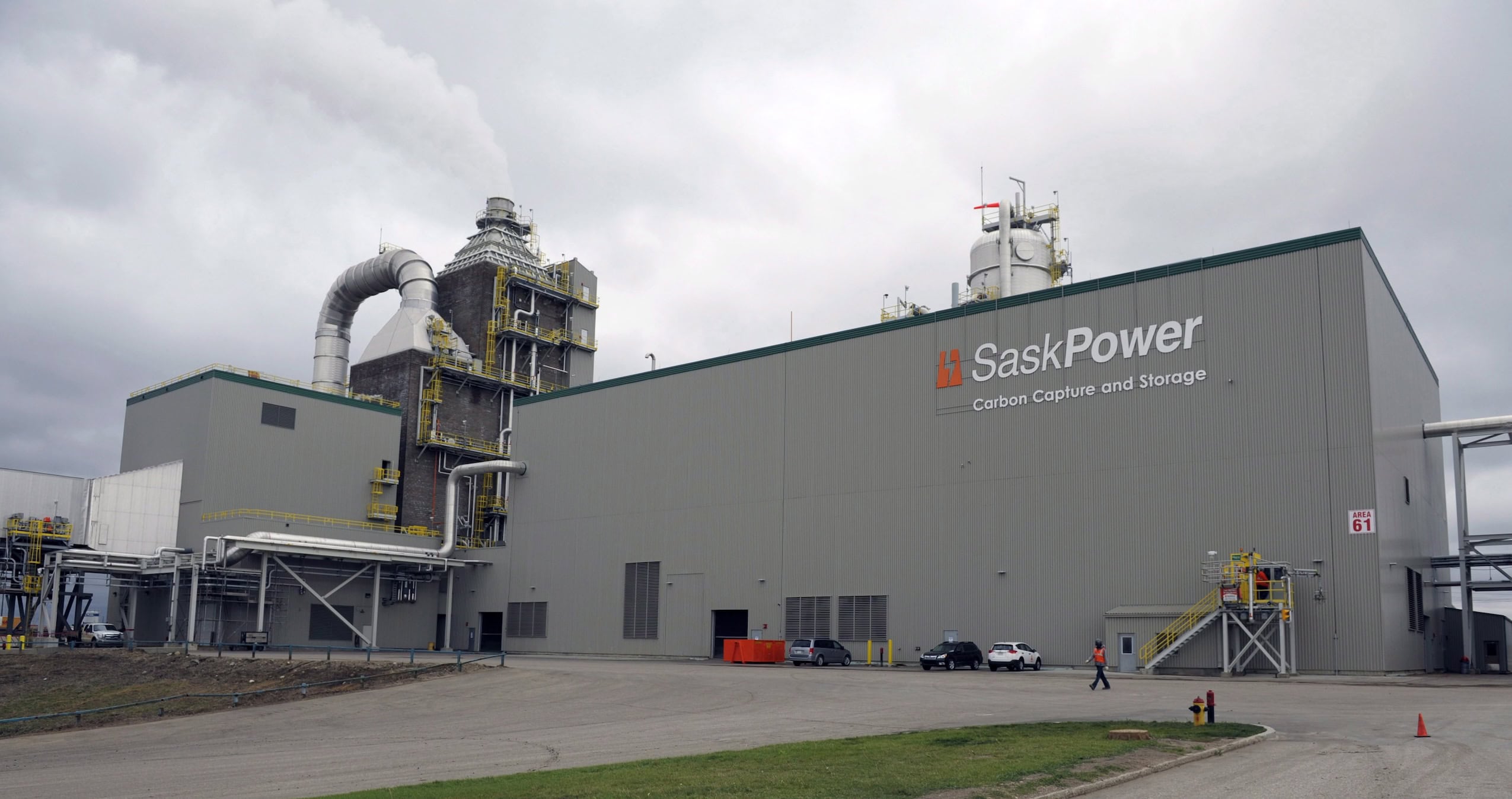 A grey carbon capture and storage building with "SaskPower" in large lettering on the side.