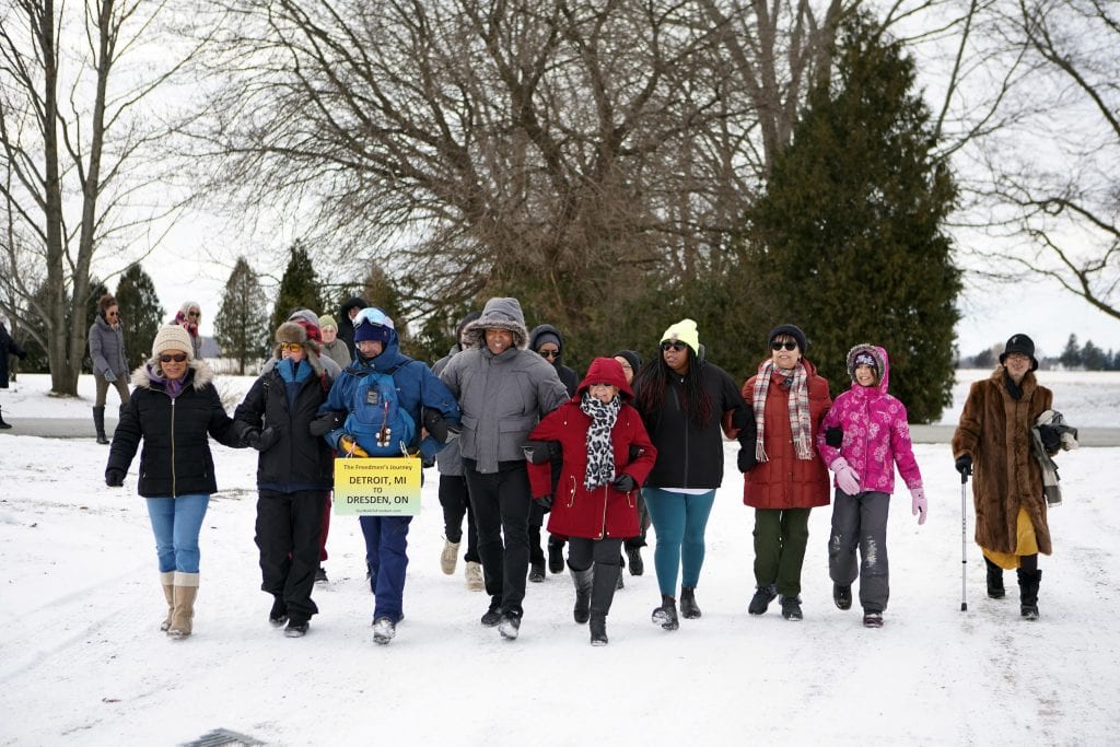 Ken Johnston links arms and walks with Black descendants of freedom seekers and local residents at the Josiah Henson Museum of African-Canadian History on the Dawn Settlement in Dresden, Ont.
