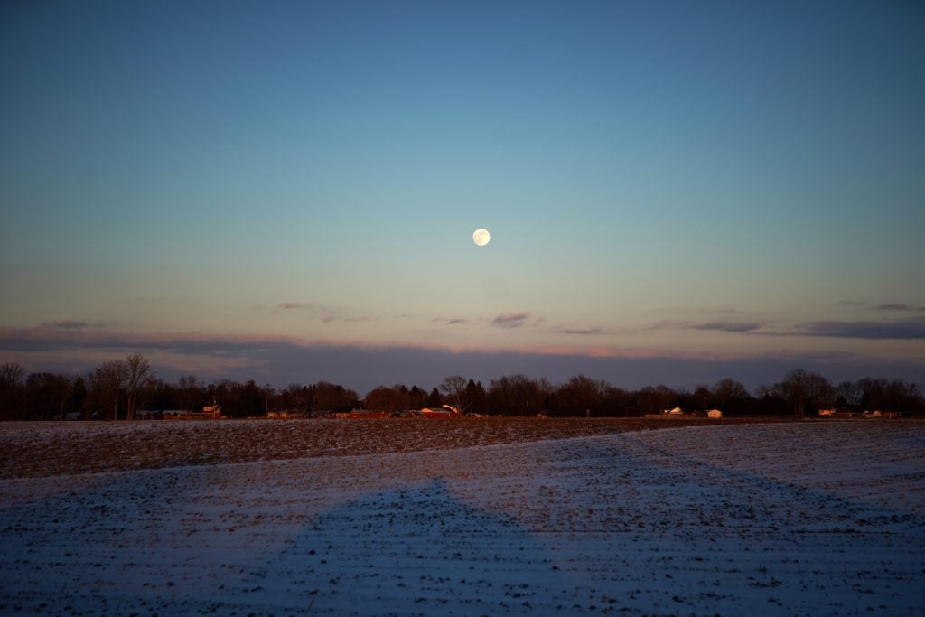 The sun sets over farm fields on Freedom Road in Dresden, Ont.