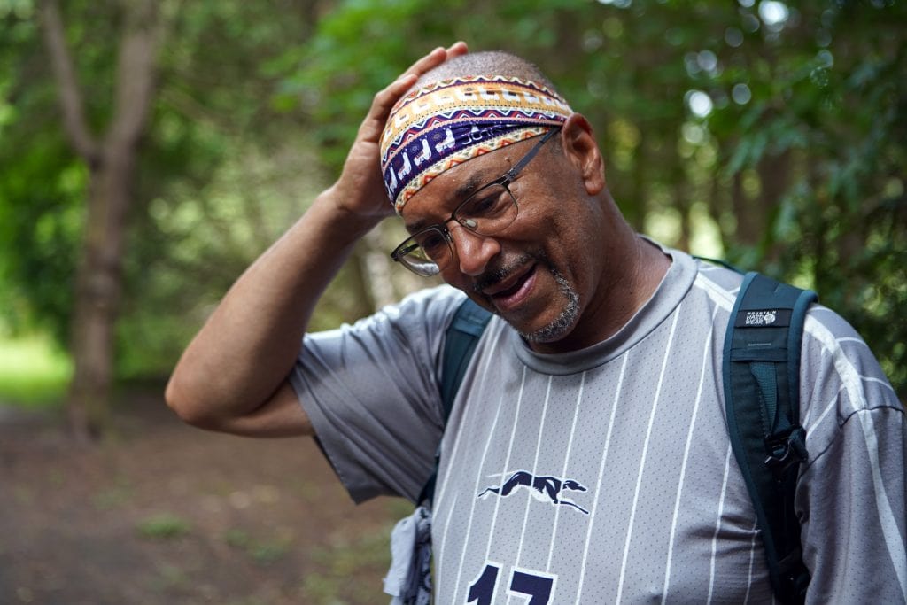 Ken Johnston pauses for a break in Fergus, Ont. while retracing an Underground Railroad route from Niagara Falls to Owen Sound on his Walk to Freedom. He is wearing glasses and a colourful bandana.