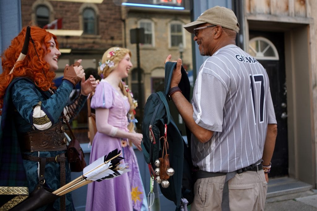 Ken Johnston, right, meets attendees in costume during a medieval fair street festival in Fergus, Ont., while retracing an Underground Railroad route from Niagara Falls to Owen Sound on his Walk to Freedom.