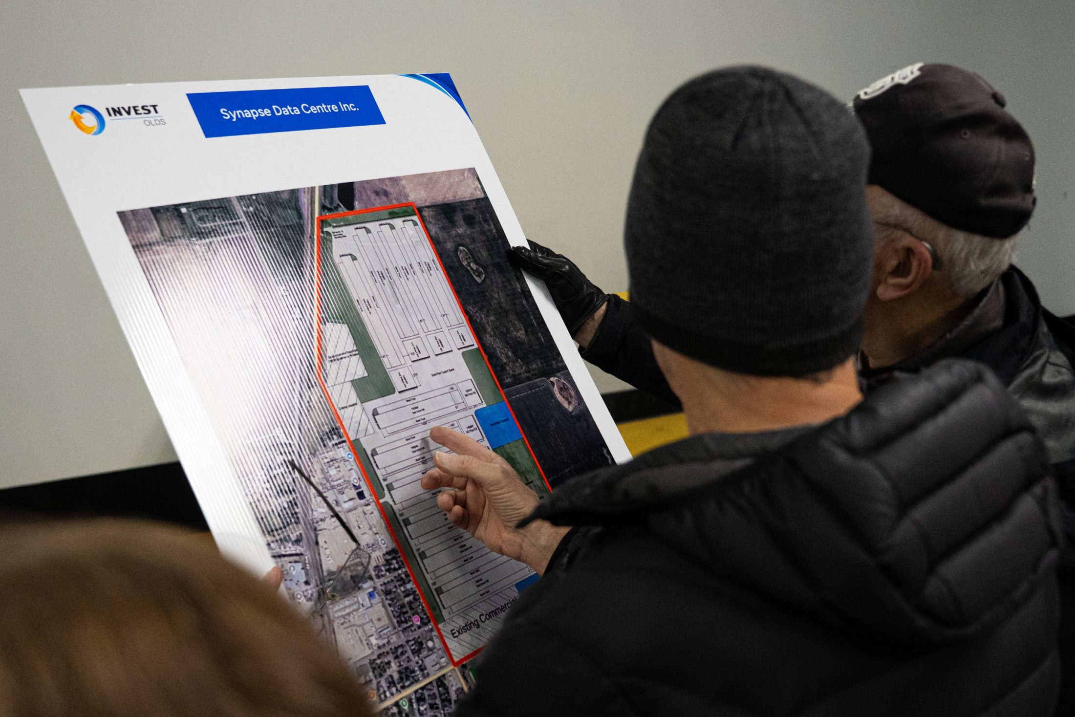 Residents look at a map showing a proposed data centre in Olds, Alberta.