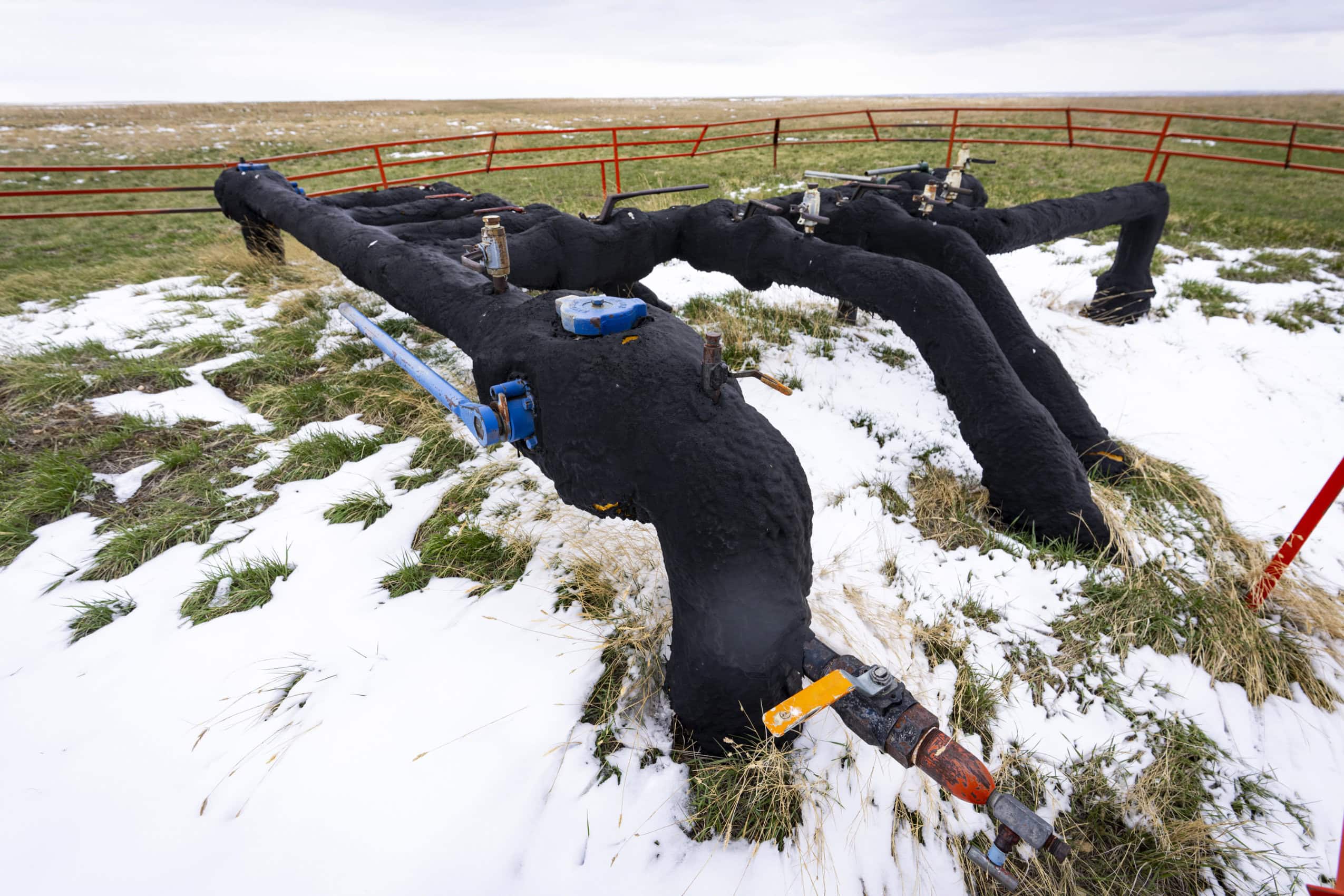 Oil and gas infrastructure in a field in rural Alberta.