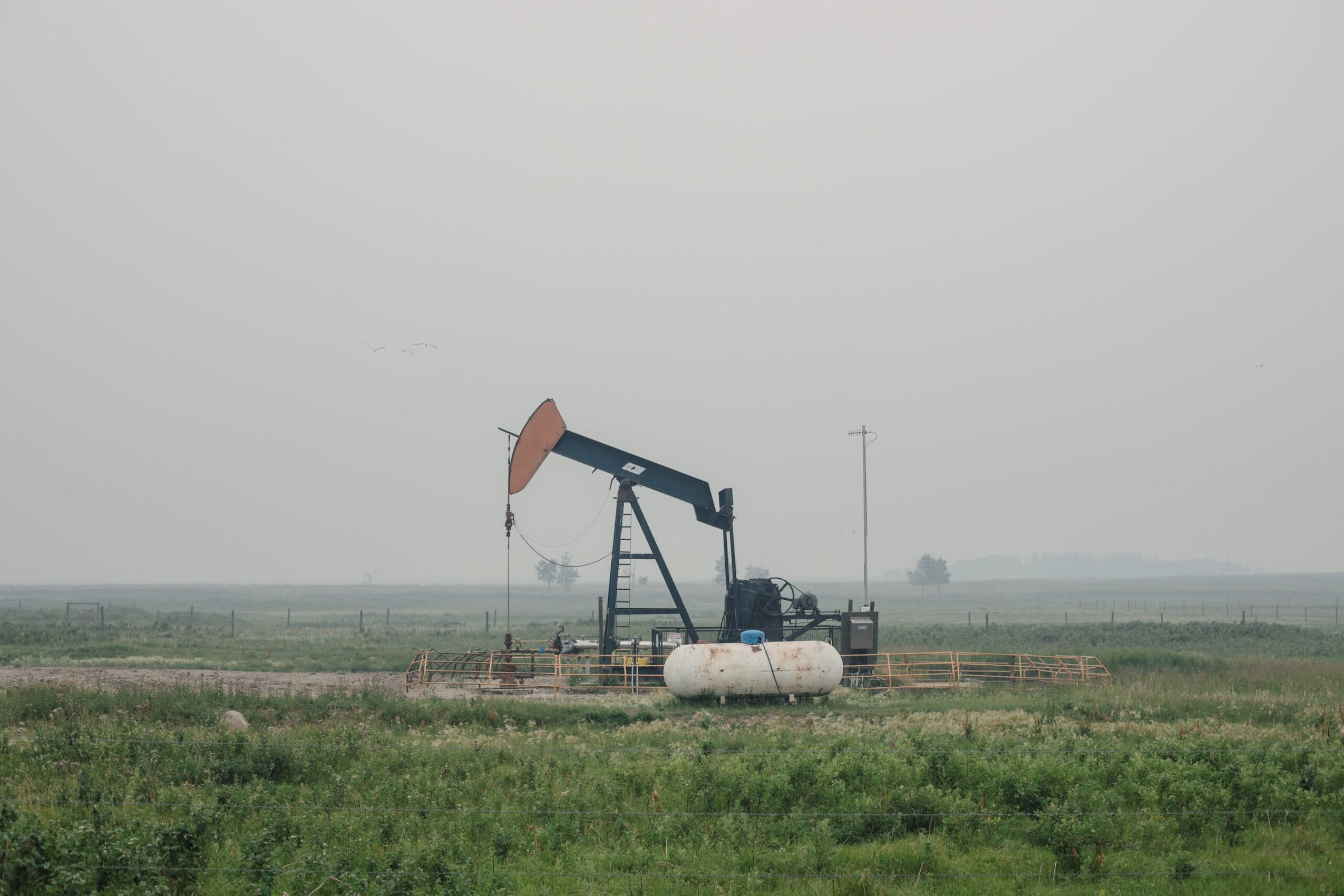 A pump jack in a field in rural Alberta.