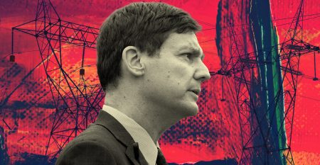 A grayscale photo of Premier David Eby superimposed over a bright red background featuring dark transmission lines