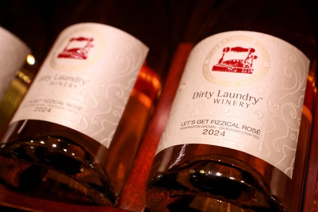 Closeup of the labels on bottles of a 2024 rose from Dirty Laundry Winery