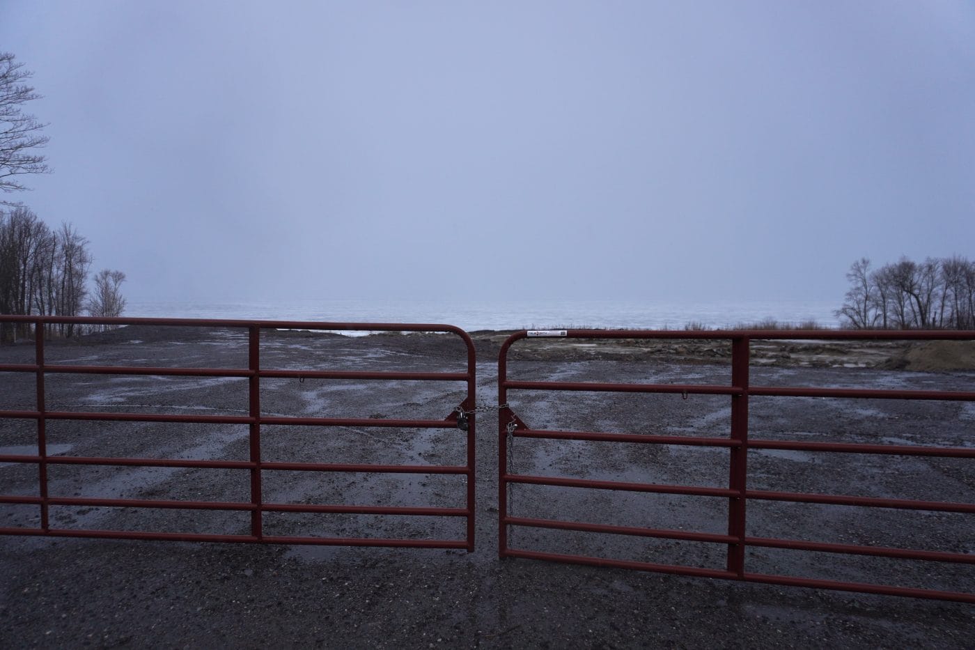 Photographed on a grey cloudy day, a gate prevents residents from entering a remediated site near Lake Nipissing where niobium mine tailings sat for decades.
