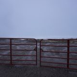 Photographed on a grey cloudy day, a gate prevents residents from entering a remediated site near Lake Nipissing where niobium mine tailings sat for decades.
